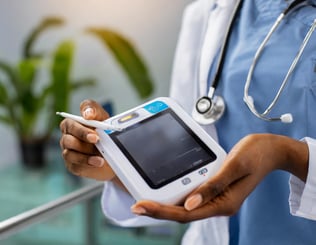 Firefly close-up shot of a healthcare professionals hands holding a small, portable medical diagnos (1)